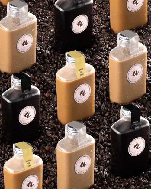 Grid of coffee bottles arranged on coffee beans