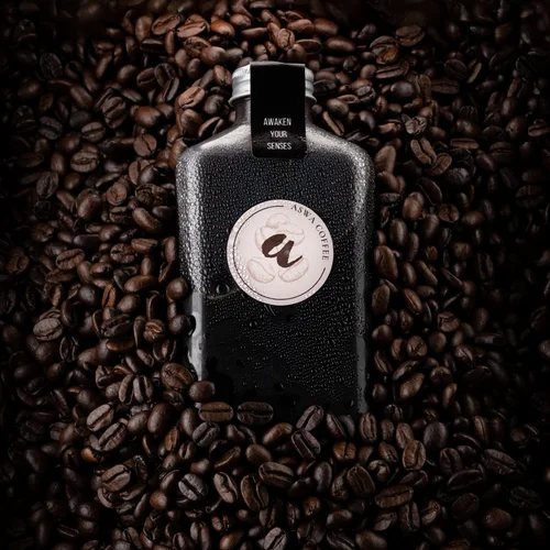 Product photo of a black coffee bottle on coffee beans